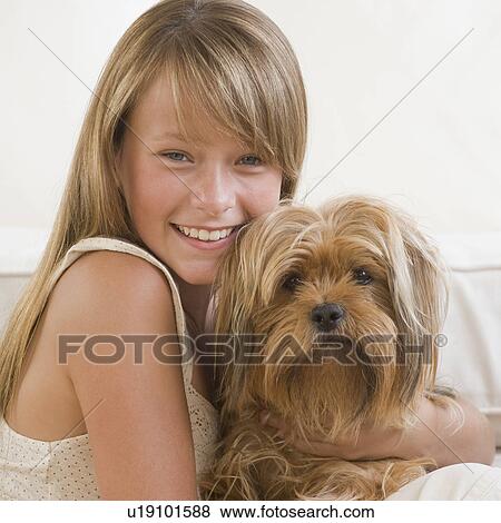 Stock Photo - Girl hugging dog. Fotosearch