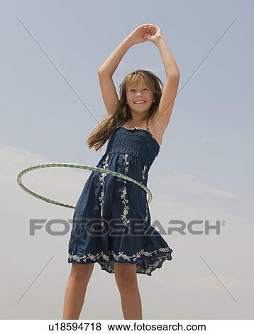 Girl hula hooping View Large Photo Image Stock Photo - Girl hula hooping. Fotosearch