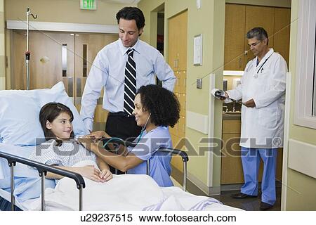 Stock Photography - Girl in hospital gurney with father and nurse. Fotosearch