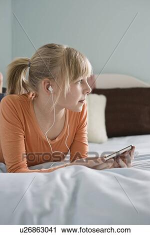 Girl listening to mp3 player View Large Photo Image Stock Image - Girl listening to mp3 player. Fotosearch