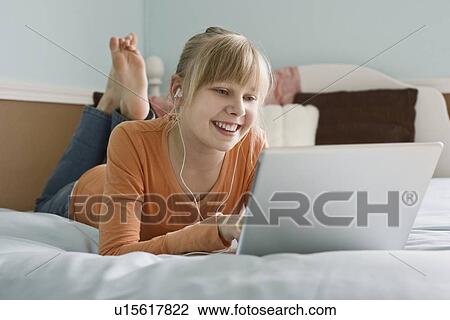 Girl looking at laptop View Large Photo Image Stock Image - Girl looking at laptop. Fotosearch