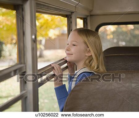 Girl looking out school bus window View Large Photo Image Stock Image - Girl looking out school bus window. Fotosearch