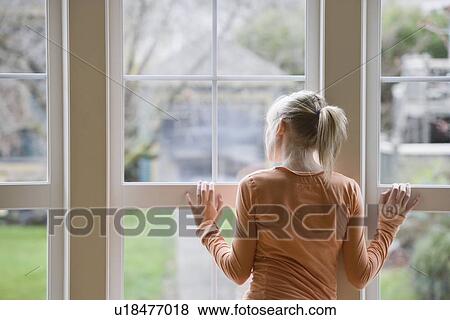 Stock Photo - Girl looking out window. Fotosearch