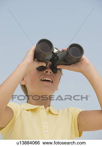 Girl looking through binoculars View Large Photo Image Stock Photograph - Girl looking through binoculars. Fotosearch