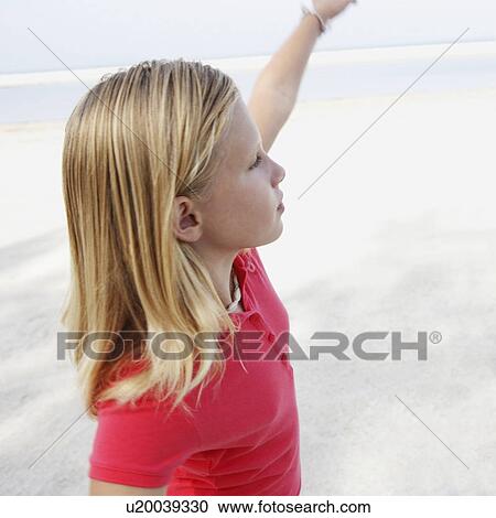 Girl on beach pointing View Large Photo Image Stock Image - Girl on beach pointing. Fotosearch