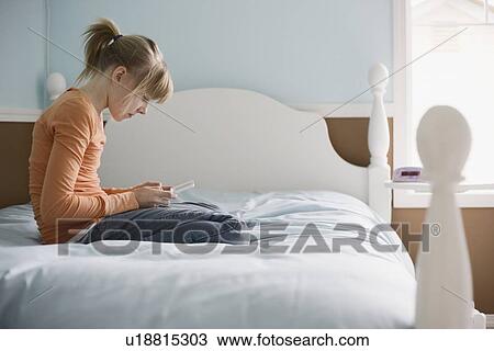 Girl playing handheld video game View Large Photo Image Stock Image - Girl playing handheld video game. Fotosearch