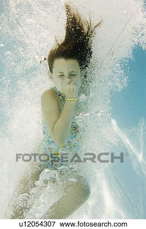 Girl plugging nose underwater View Large Photo Image Stock Photo - Girl plugging nose underwater. Fotosearch