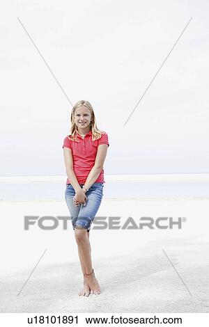 Stock Image - Girl posing on beach. Fotosearch
