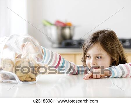 Girl reaching into cookie jar View Large Photo Image Stock Image - Girl reaching into cookie jar. Fotosearch