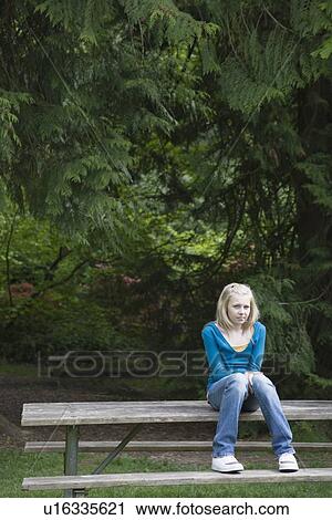 Girl sitting on park bench View Large Photo Image Stock Image - Girl sitting on park bench. Fotosearch
