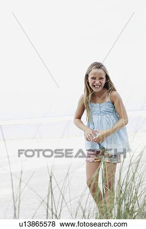 Stock Photo - Girl smiling on beach. Fotosearch