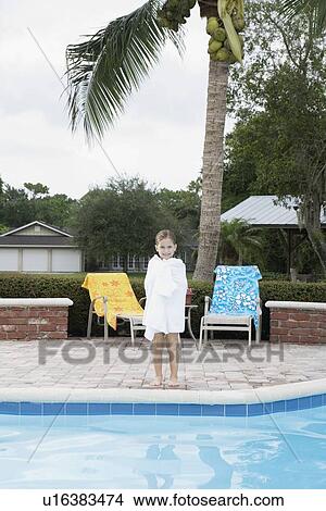 Girl standing at edge of swimming pool View Large Photo Image Picture - Girl standing at edge of swimming pool. Fotosearch