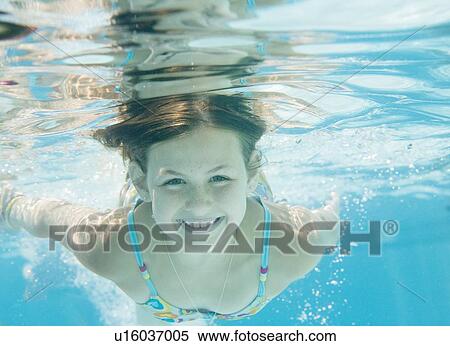 Girl swimming underwater View Large Photo Image Stock Photography - Girl swimming underwater. Fotosearch