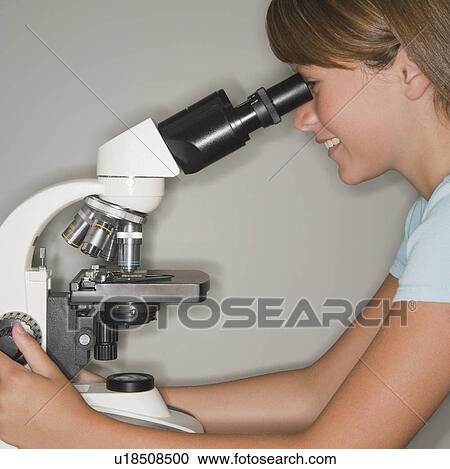 Stock Image - Girl using microscope. Fotosearch