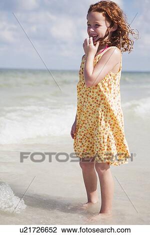 Girl wading in ocean View Large Photo Image Stock Image - Girl wading in ocean. Fotosearch