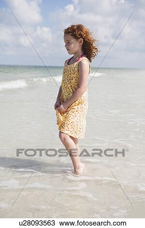 Girl wading in ocean View Large Photo Image Stock Image - Girl wading in ocean. Fotosearch