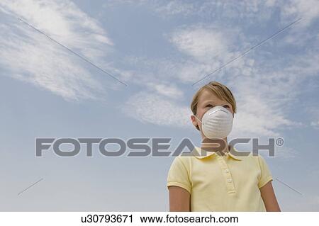 Stock Image - Girl wearing dust mask. Fotosearch