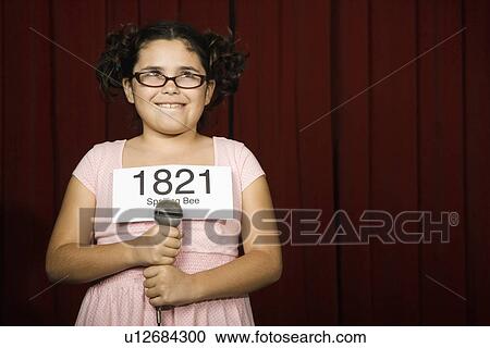 Girl wearing number on stage View Large Photo Image Stock Image - Girl wearing number on stage. Fotosearch