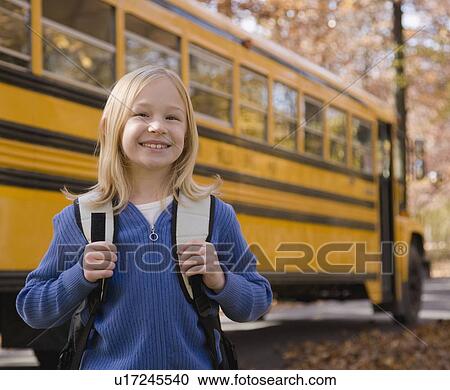 Girl with backpack in front of school bus View Large Photo Image Stock Image - Girl with backpack in front of school bus. Fotosearch