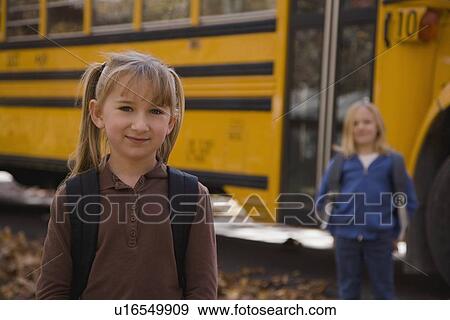 Girl with backpack in front of school bus View Large Photo Image Stock Photo - Girl with backpack in front of school bus. Fotosearch