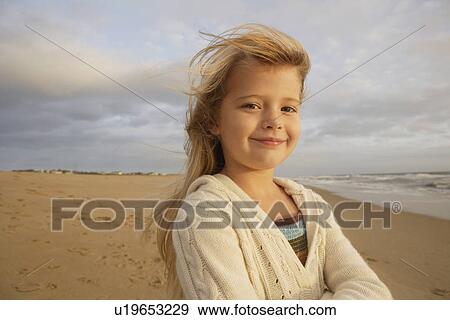 Stock Photo - Girl with hair blowing at beach. Fotosearch