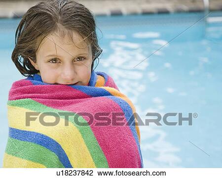 Girl wrapped in a towel at edge of swimming pool View Large Photo Image Stock Image - Girl wrapped in a towel at edge of swimming pool. Fotosearch