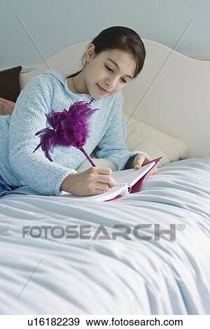 Girl writing in diary View Large Photo Image Stock Photo - Girl writing in diary. Fotosearch