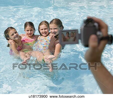Girls being videotaped in swimming pool View Large Photo Image Stock Image - Girls being videotaped in swimming pool. Fotosearch