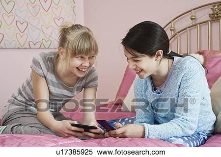 Girls dialing cell phones View Large Photo Image Stock Photography - Girls dialing cell phones. Fotosearch