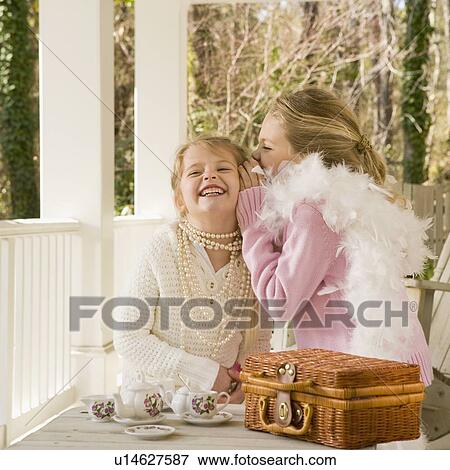 Stock Photo - Girls having tea party on porch. Fotosearch