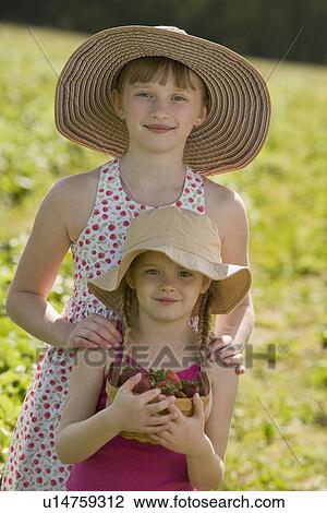 Girls picking fresh strawberries View Large Photo Image Stock Image - Girls picking fresh strawberries. Fotosearch