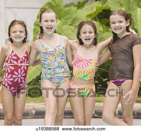 Stock Photo - Girls posing by swimming pool. Fotosearch