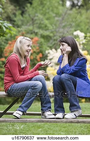 Girls talking in park View Large Photo Image Stock Photo - Girls talking in park. Fotosearch