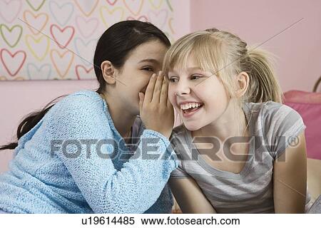 Girls telling secret View Large Photo Image Stock Photography - Girls telling secret. Fotosearch