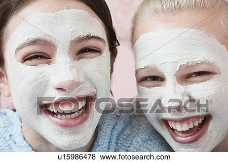 Stock Photo - Girls with facial treatment laughing. Fotosearch