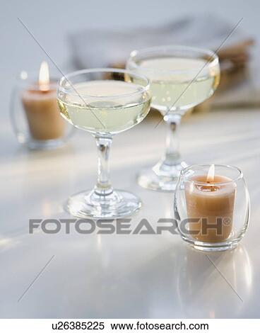 Stock Photography - Glasses of champagne next to candles. Fotosearch