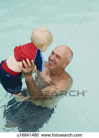 Grandfather and grandson in swimming pool View Large Photo Image Stock Image - Grandfather and grandson in swimming pool. Fotosearch
