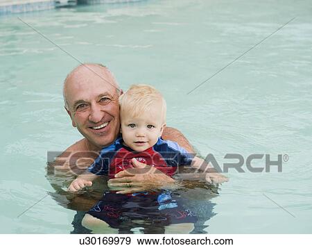 Grandfather and grandson posing in swimming pool View Large Photo Image Stock Photo - Grandfather and grandson posing in swimming pool. Fotosearch