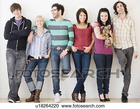 Group of friends leaning on wall View Large Photo Image Stock Image - Group of friends leaning on wall. Fotosearch