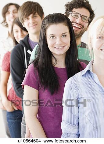 Group of friends standing in row View Large Photo Image Picture - Group of friends standing in row. Fotosearch