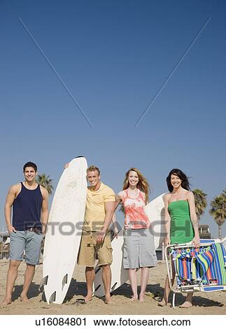 Group of friends standing on beach View Large Photo Image Stock Image - Group of friends standing on beach. Fotosearch