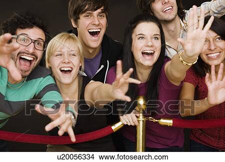 Group of people reaching across velvet rope View Large Photo Image Picture - Group of people reaching across velvet rope. Fotosearch