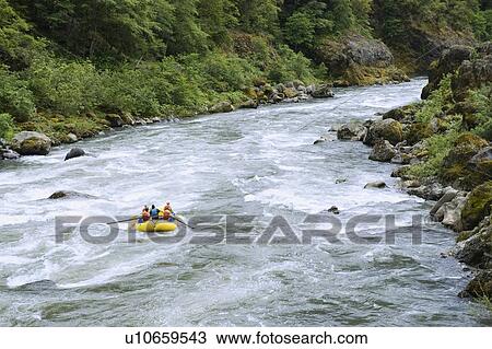 Stock Image - Group whitewater rafting. Fotosearch