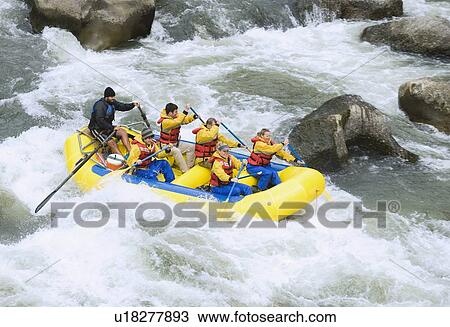 Stock Image - Group whitewater rafting. Fotosearch