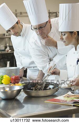 Head chef inspecting cooking techniques View Large Photo Image Stock Image - Head chef inspecting cooking techniques. Fotosearch