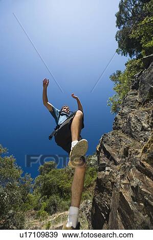 Hiker jumping down rocky trail View Large Photo Image Stock Photo - Hiker jumping down rocky trail. Fotosearch
