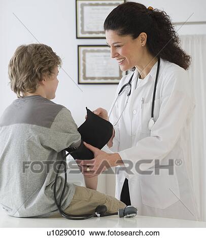 Hispanic female doctor taking child’s blood pressure View Large Photo Image Stock Image - Hispanic female doctor taking child’s blood pressure. Fotosearch