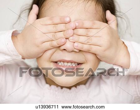 Stock Image - Hispanic girl covering eyes. Fotosearch