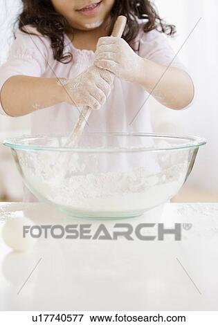 Hispanic girl mixing dough View Large Photo Image Stock Photo - Hispanic girl mixing dough. Fotosearch