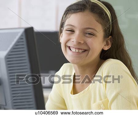 Hispanic girl next to computer View Large Photo Image Stock Photo - Hispanic girl next to computer. Fotosearch